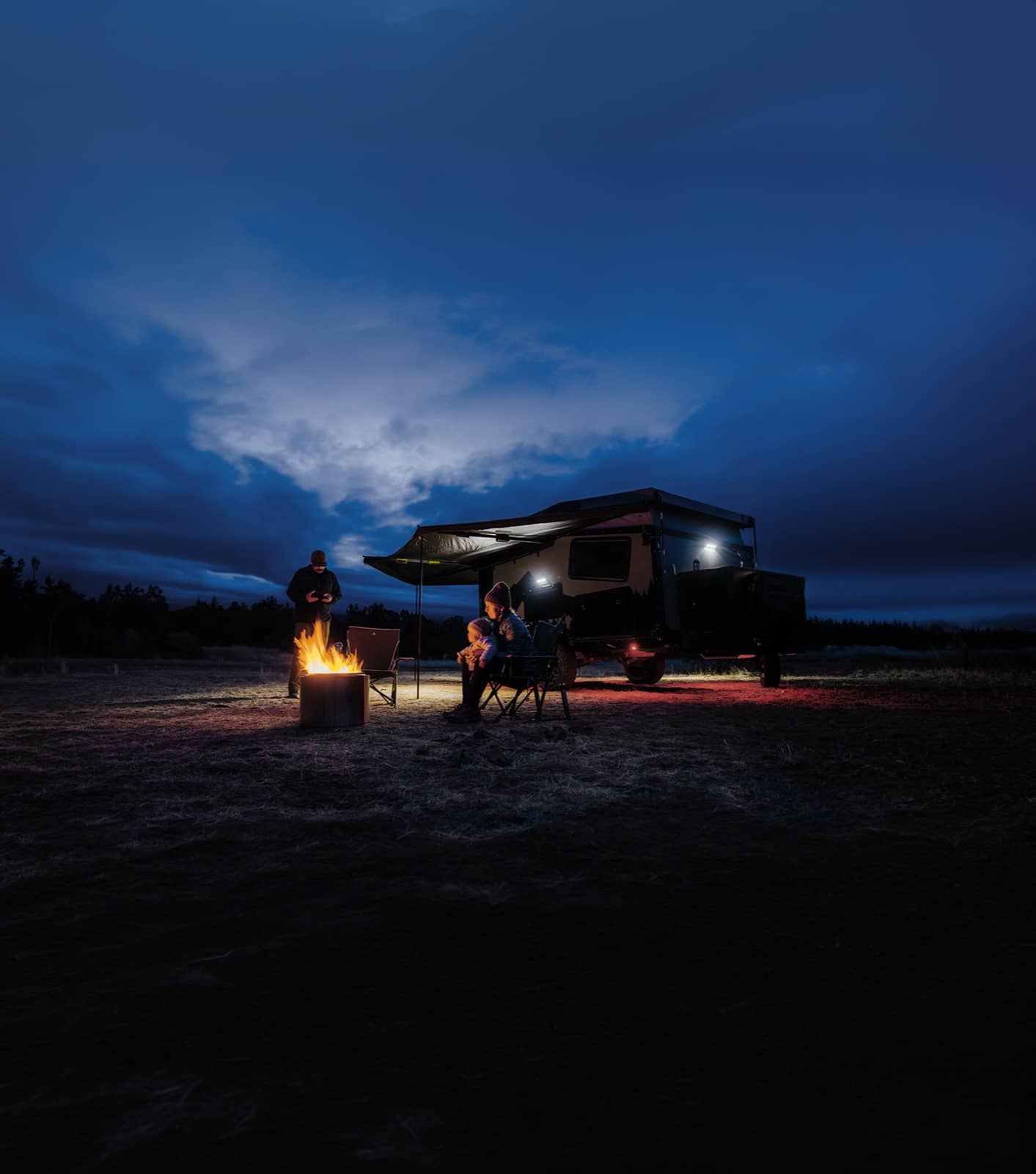 Family camper van parked at night with twinkling lights